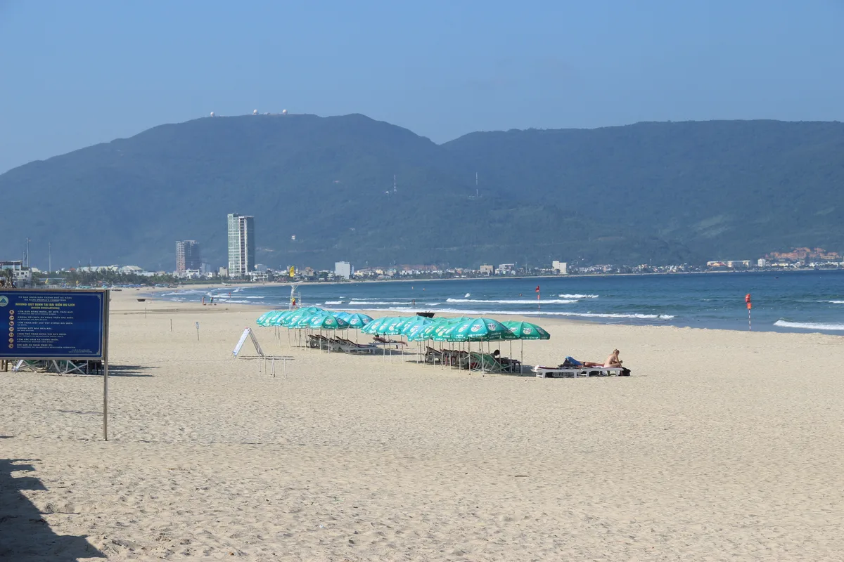 Broad sandy shoreline and calm water at My Khe Beach in Da Nang