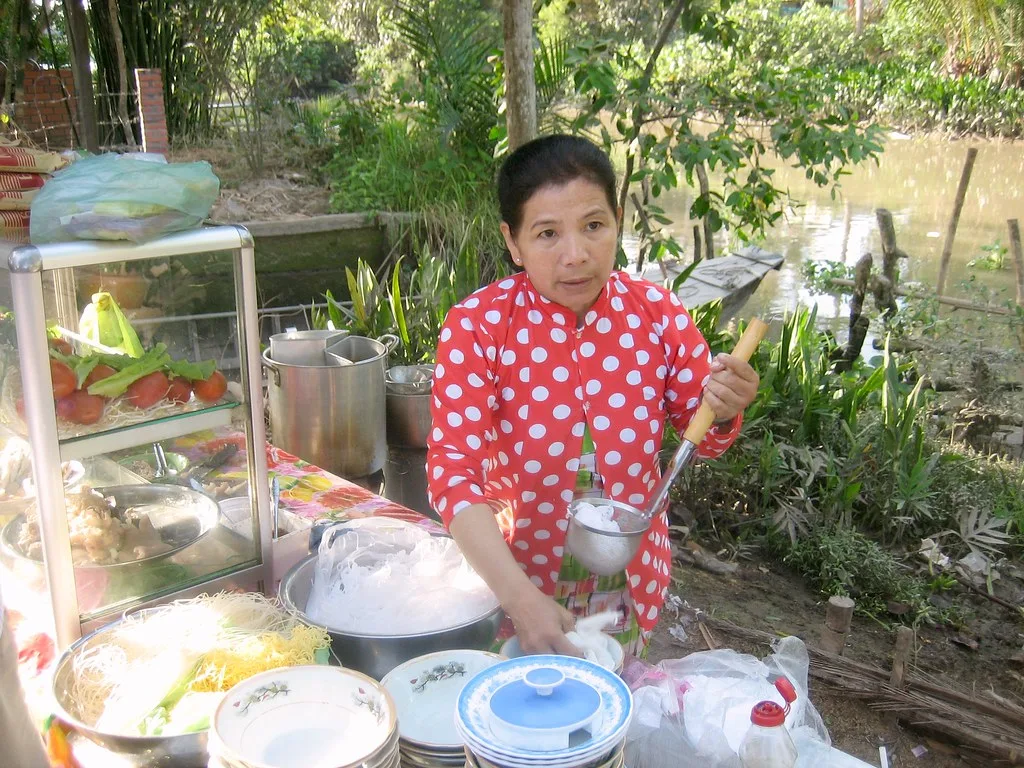 Noodle vendor preparing breakfast beside a canal on a two-day Can Tho itinerary