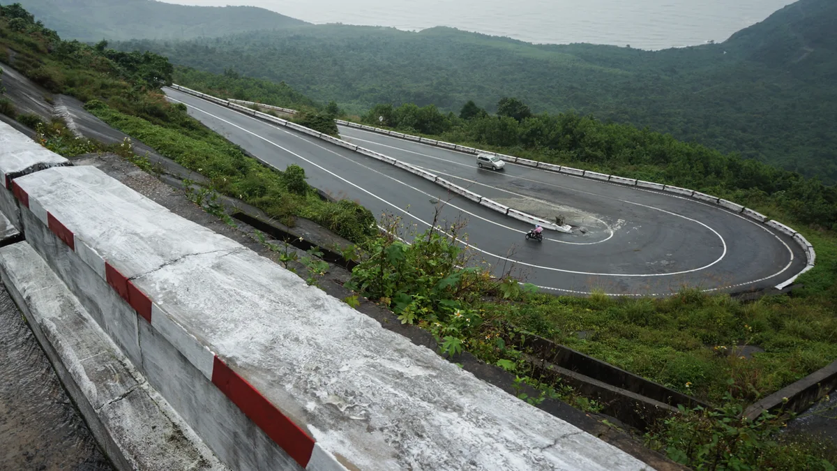 Hairpin bends climbing through the green mountains of Hai Van Pass