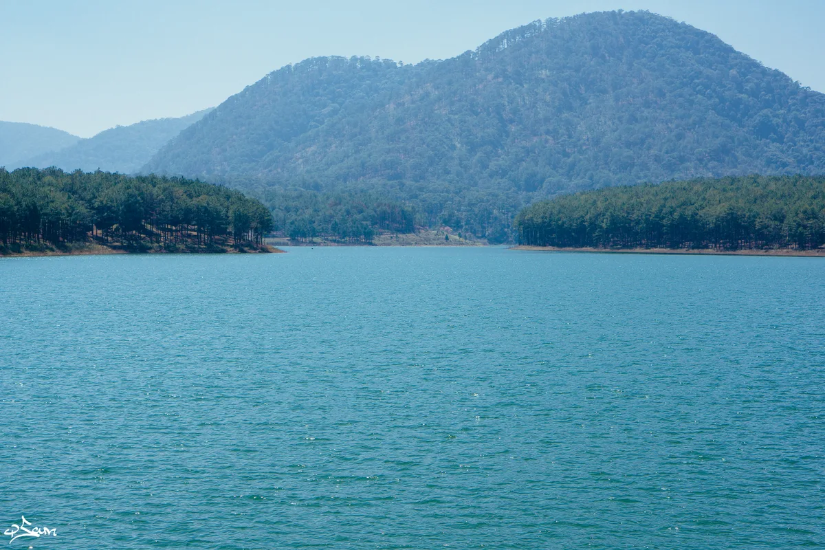 Tuyen Lam Lake and pine-covered hills outside Da Lat on a clear morning