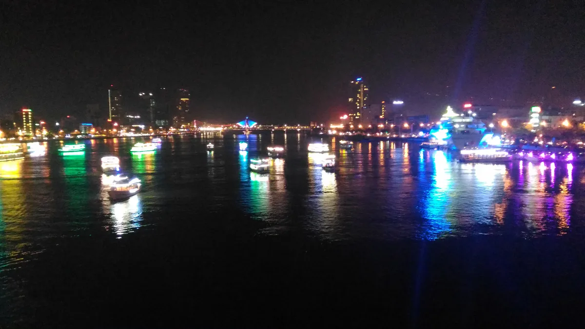 Da Nang riverfront skyline reflecting colorful lights across the Han River