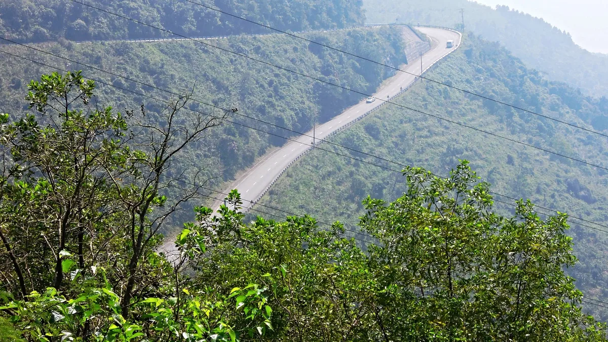 Mountain road winding along the forested slopes of Hai Van Pass