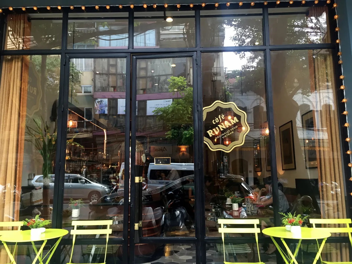 Street-facing entrance and outdoor tables at Cafe RuNam in Hanoi