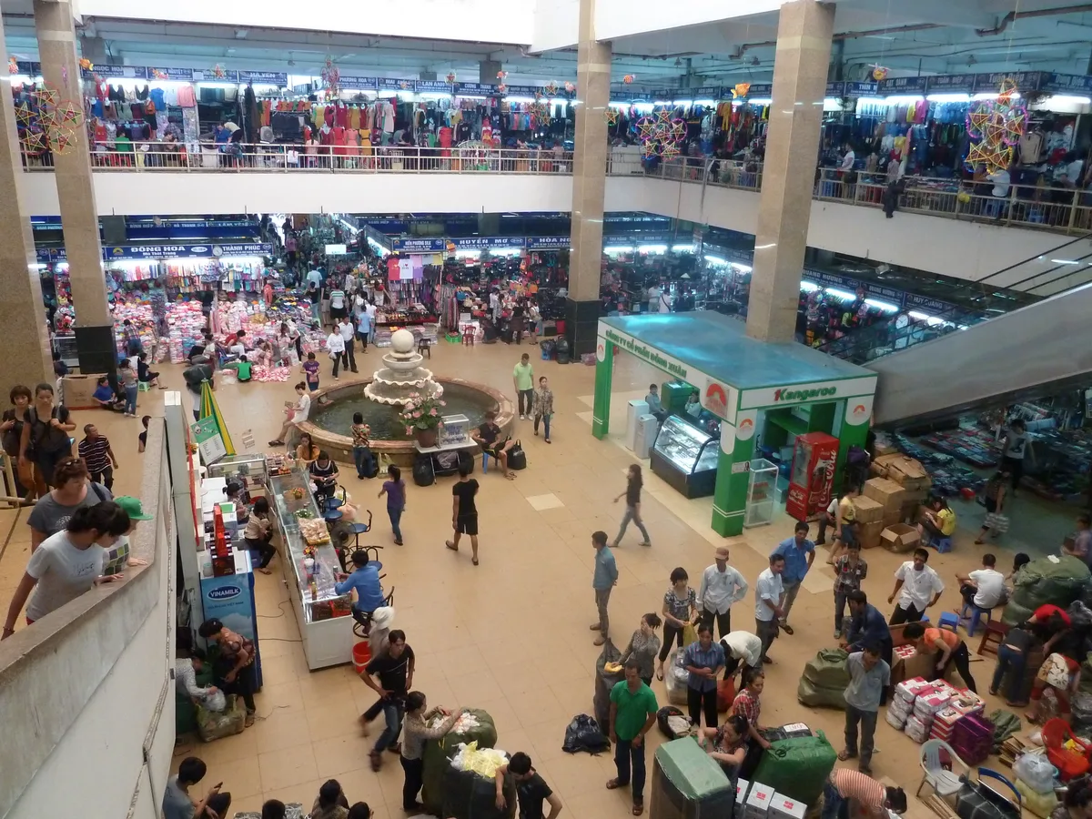 Shoppers browsing stalls and merchandise inside Dong Xuan Market in Hanoi