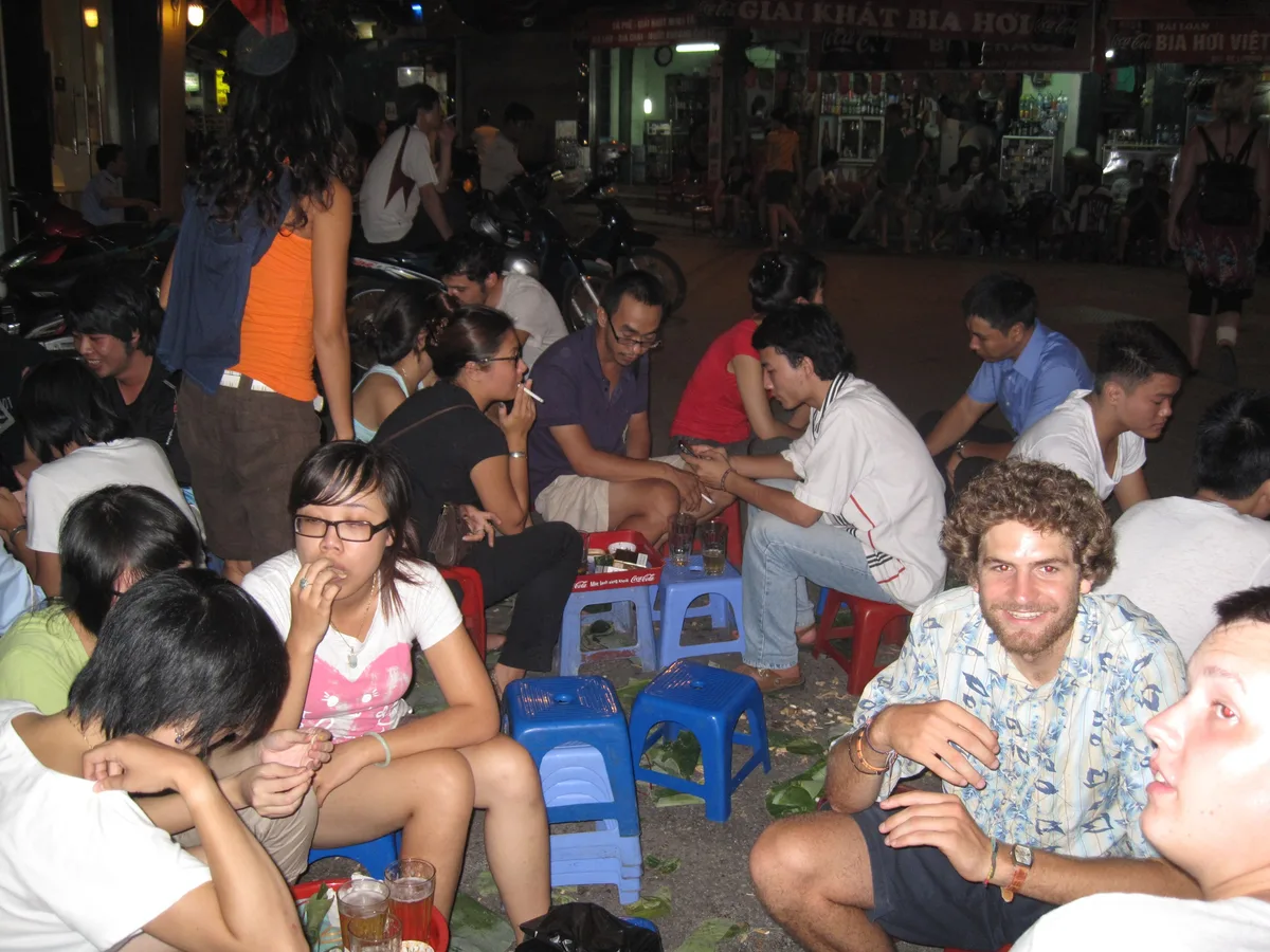 People gathering around a Hanoi bia hoi venue during an evening out
