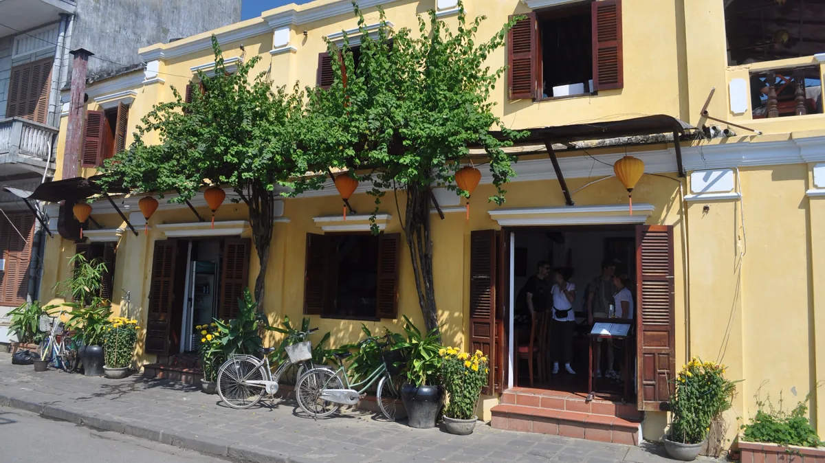 Historic yellow shop houses lining a street in Hoi An Ancient Town