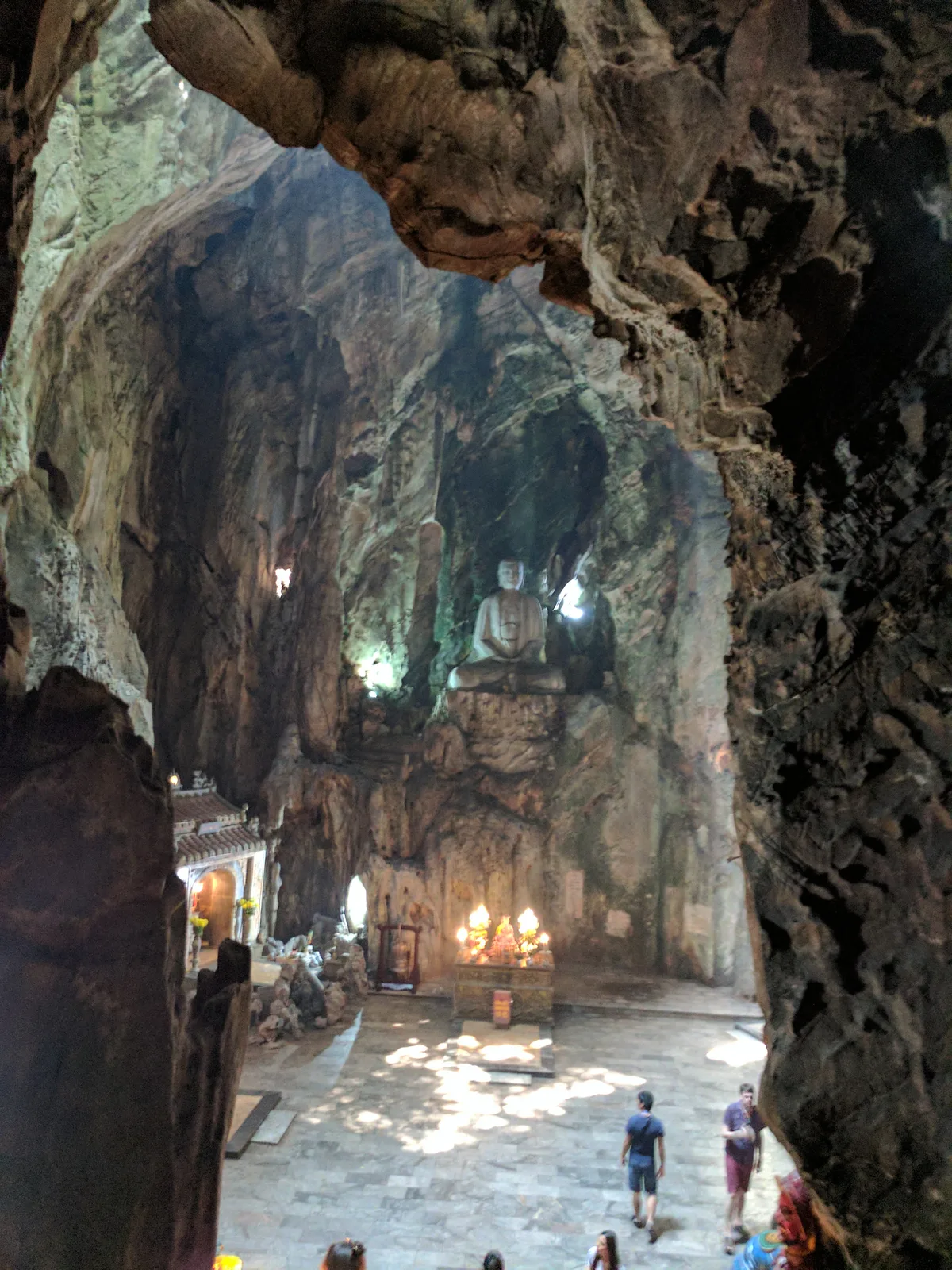 Buddhist shrine and visitors inside Huyen Khong Cave at Marble Mountains