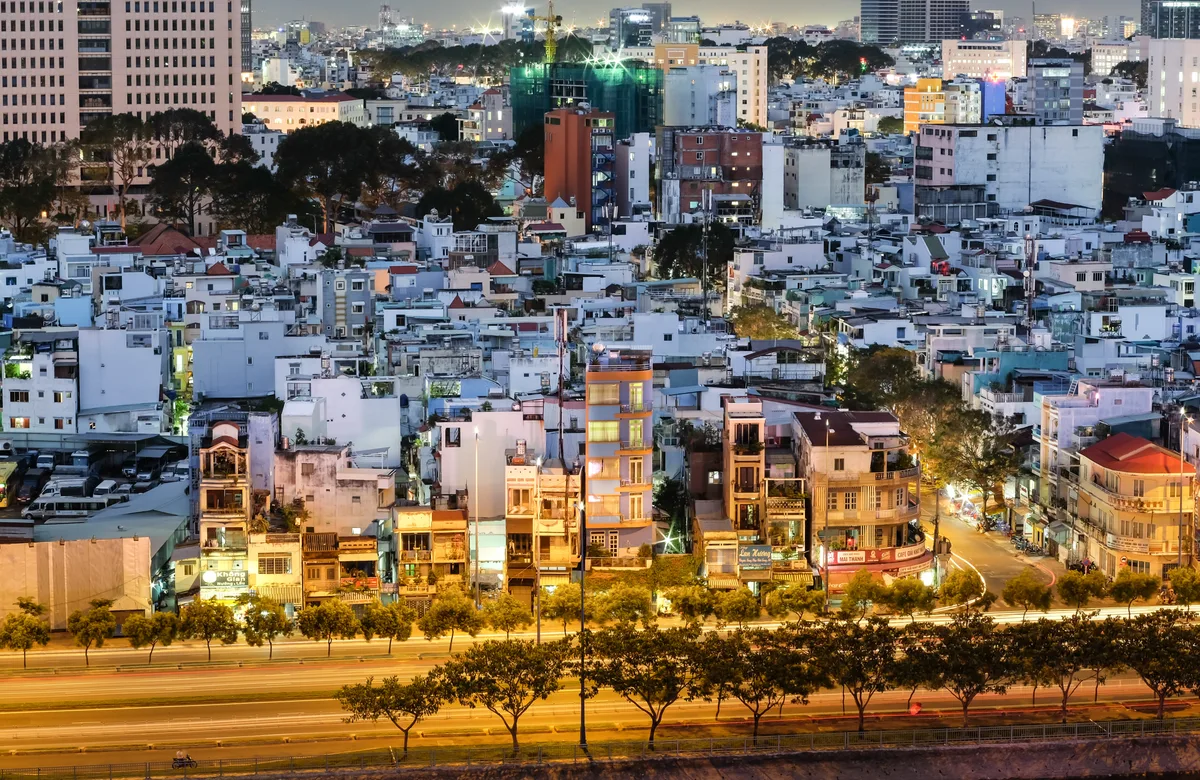 Dense Ho Chi Minh City neighborhoods and towers glowing at dusk in southern Vietnam