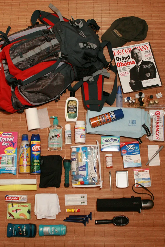 Backpack, insect repellent, medicines, and first-aid supplies arranged before a trip