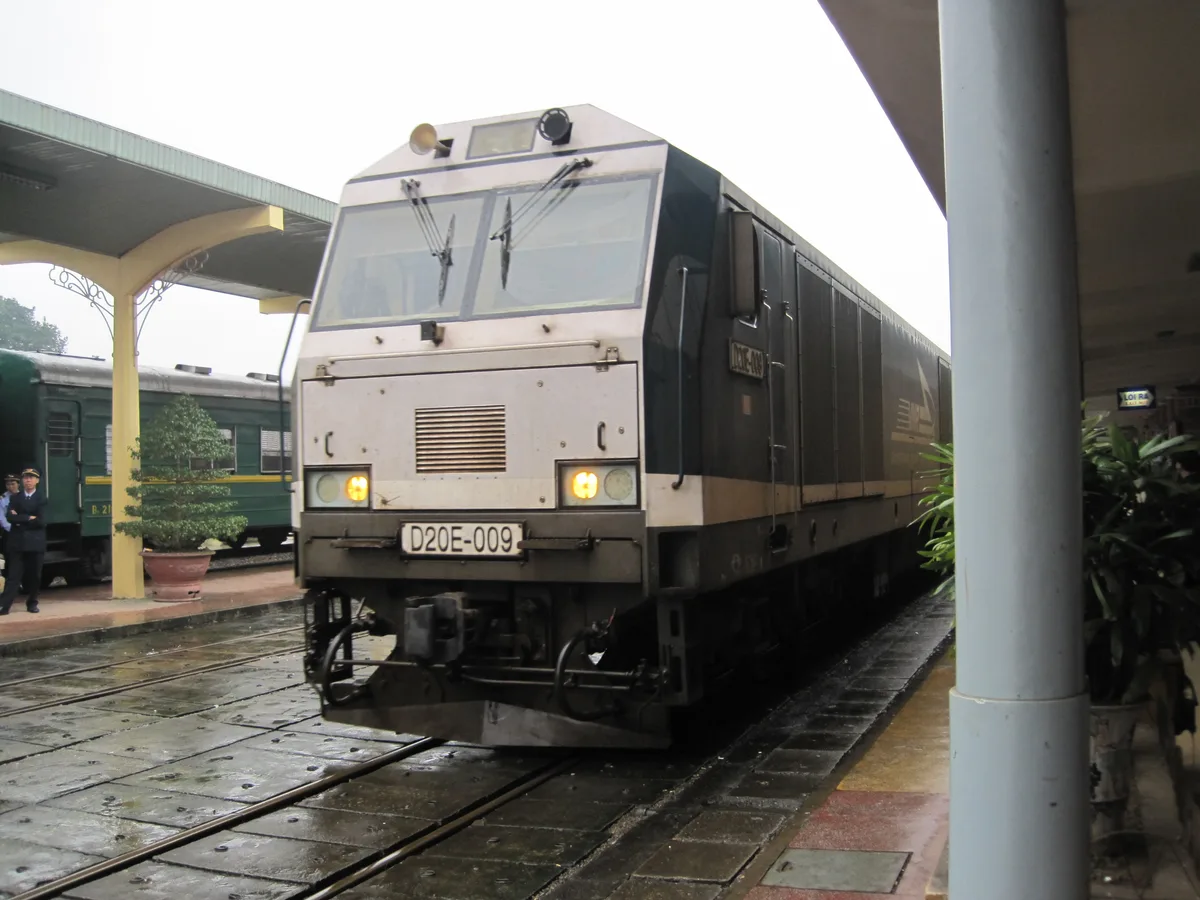 Passenger train waiting beside a platform on Vietnam's national rail network