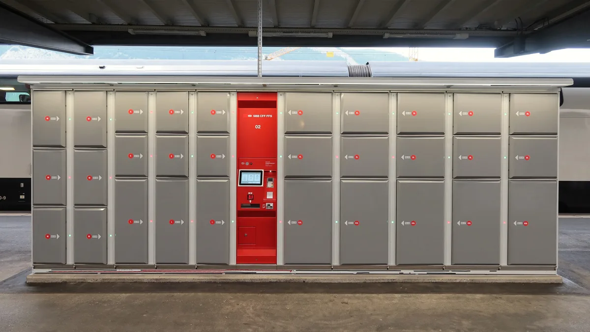 Self-service luggage lockers beside a railway platform during an insured trip